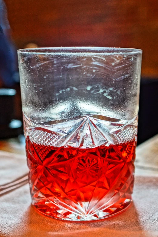 a glass of wine sitting on a table