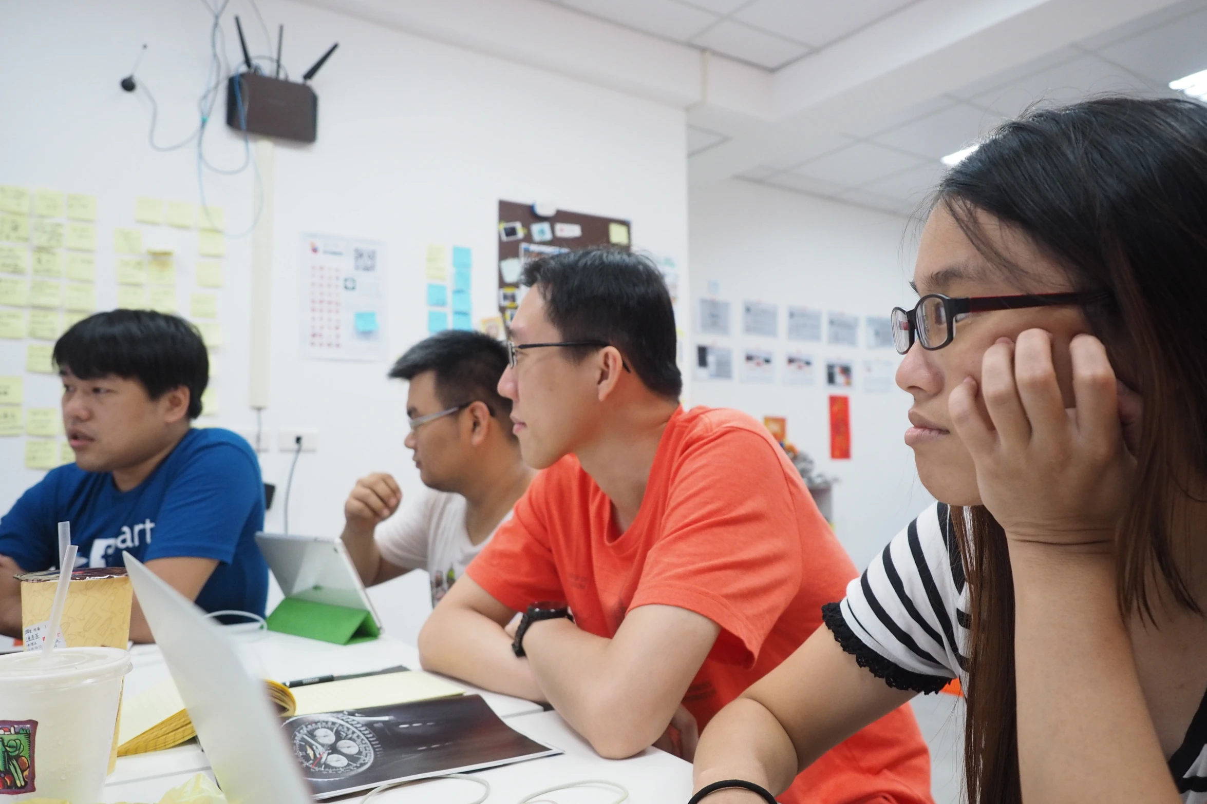 three people are using their laptop computers