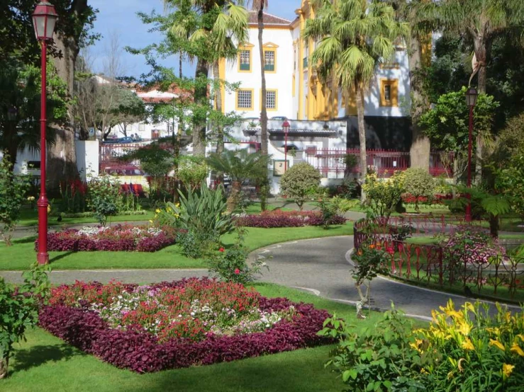 a pathway surrounded by colorful flowers in a garden