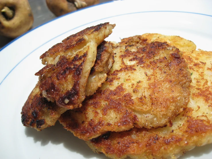 three pieces of chicken sitting on top of a white plate