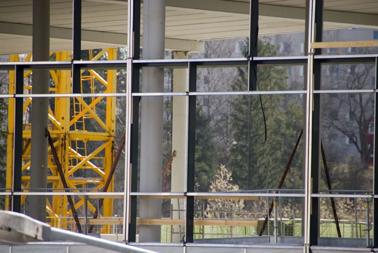 a view of some buildings under construction and a yellow crane