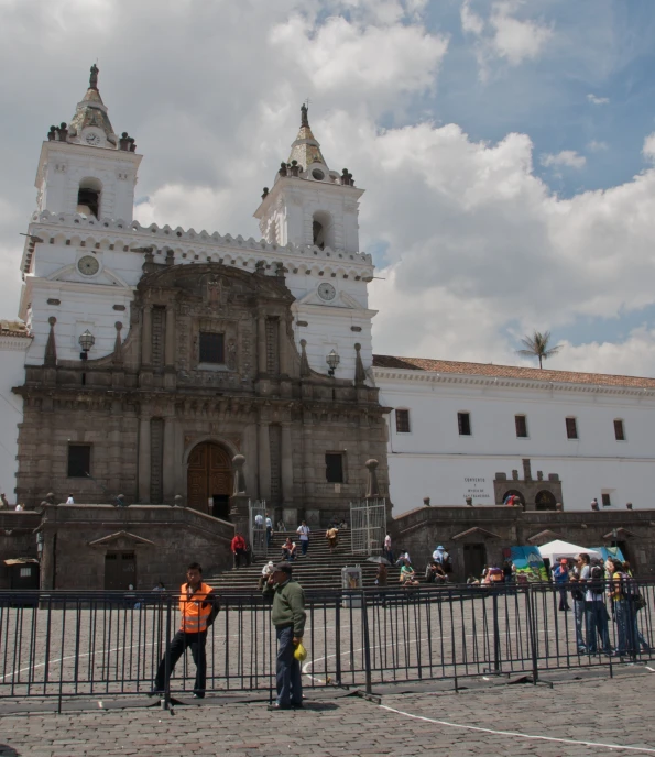 the old white building has two people near it