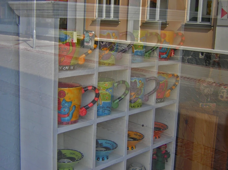 a display case in the window displays many different designs