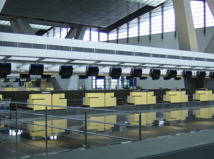 luggage claim area with rows of metal and wood