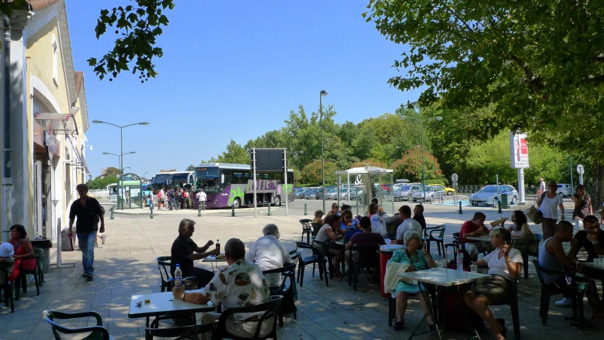 a group of people are sitting at tables