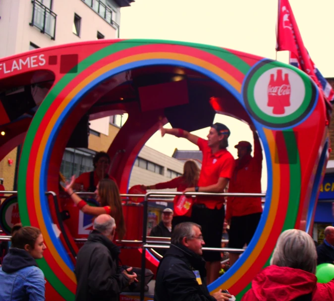 people are riding in a fake carnival float