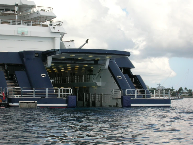 large blue boat with water front entryway to ship