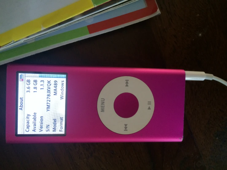 the pink ipod is connected to a small power bank