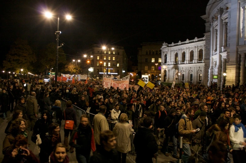 a huge crowd of people outside at night