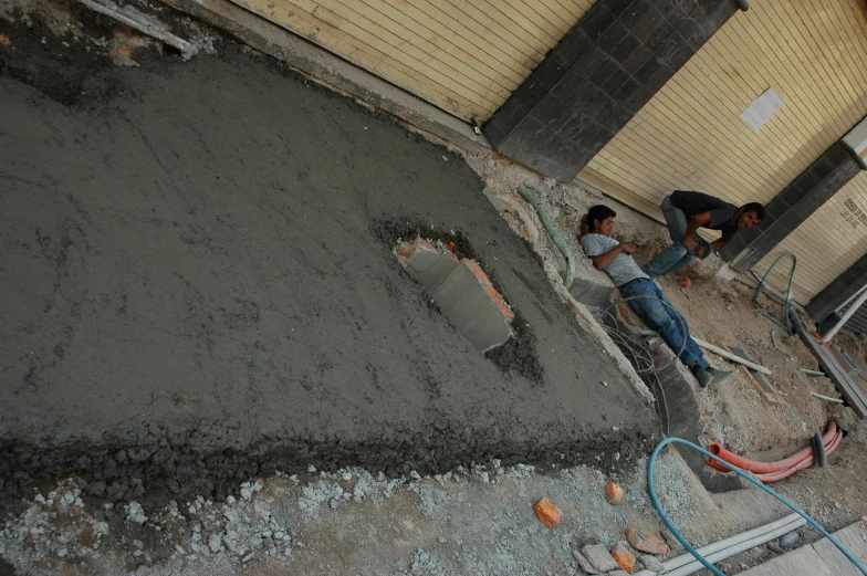 two people laying on top of a construction site