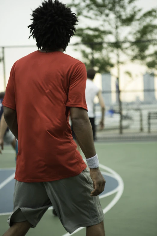 there is a man with a hair band playing on the court