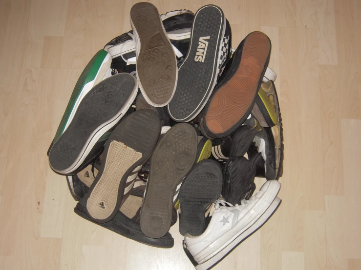 several different pairs of shoes lay on top of each other