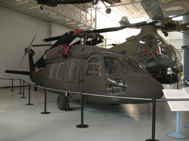 a gray military helicopter is on display in a museum