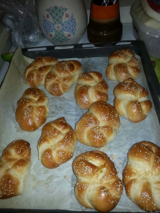 small breaded buns cooling on a sheet of parchment paper