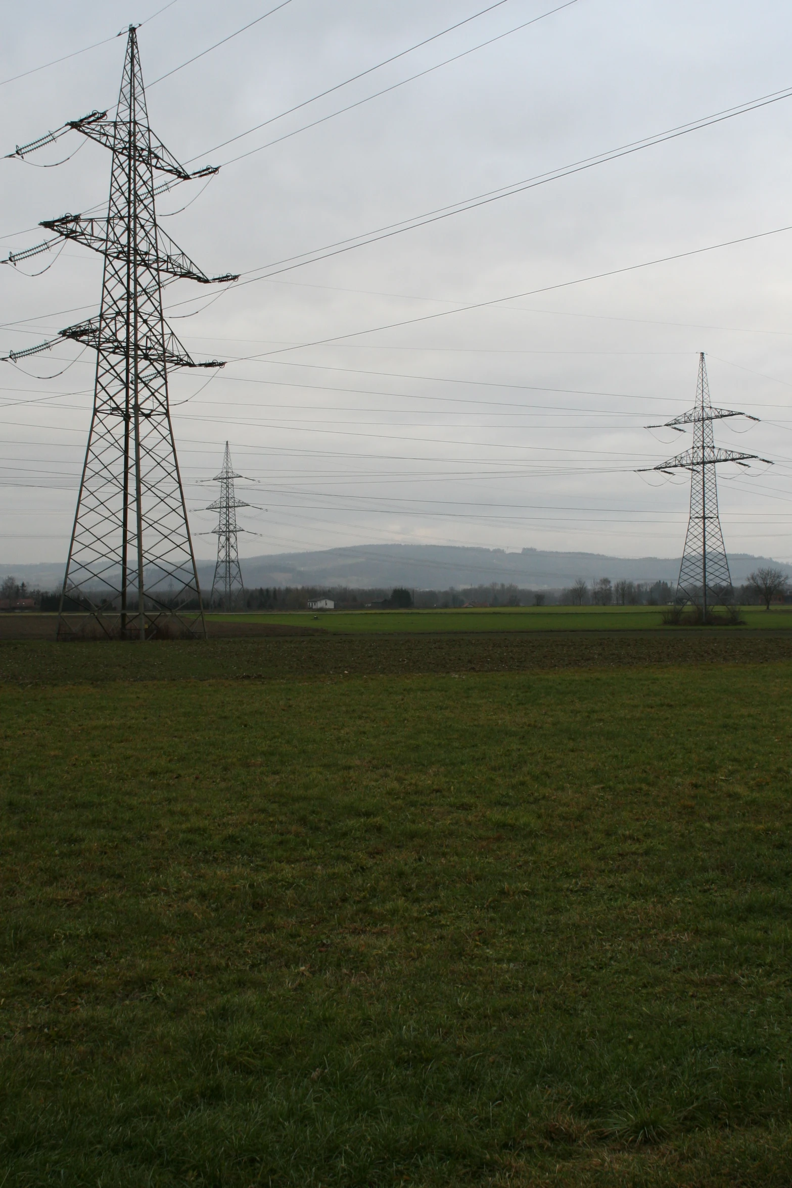 a field with telephone towers in the distance