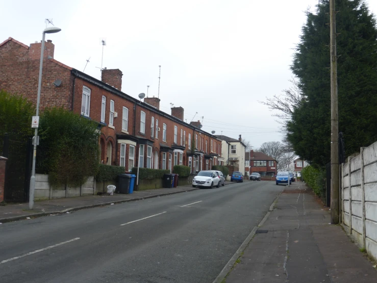 many cars parked on side of buildings along the street