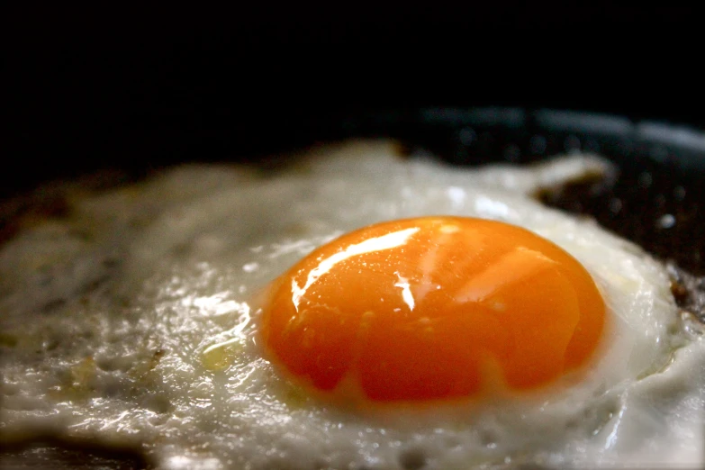 an egg is fried on the same pan as another plate