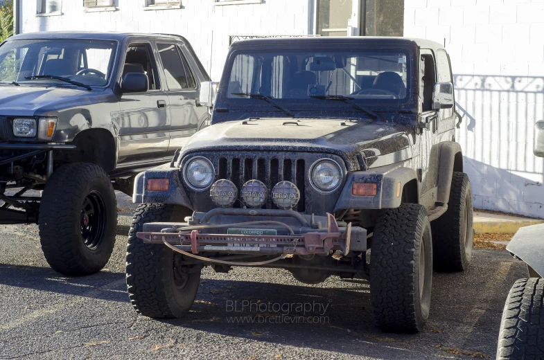 two jeeps are parked next to each other