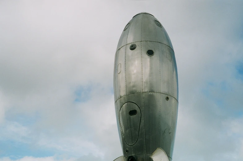 an air plane is parked and being held up with people walking in the area