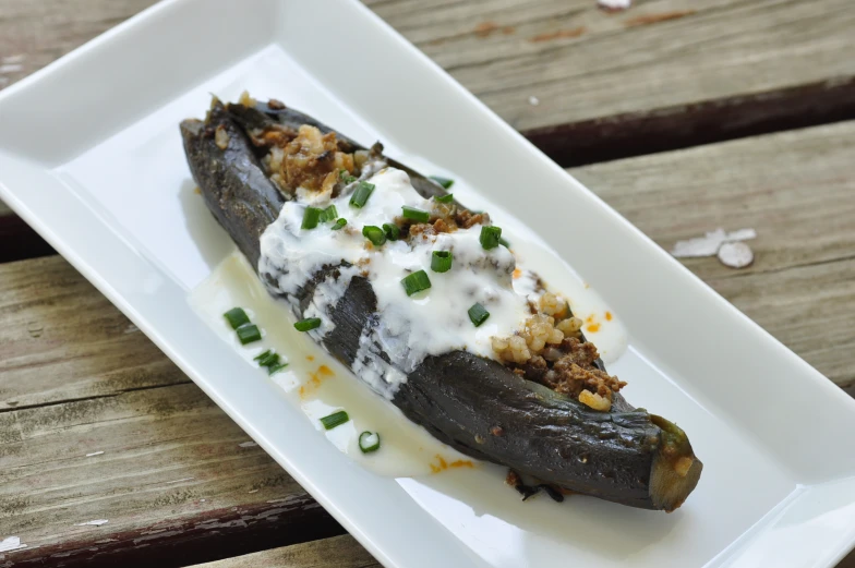the eggplant has been stuffed with some cheese and chives