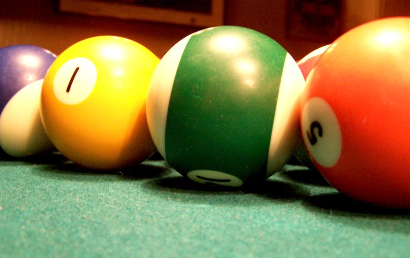 five pool balls lined up and the number one on them
