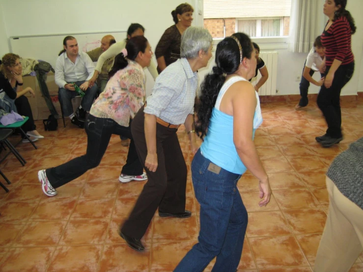 people are in a room doing exercises together