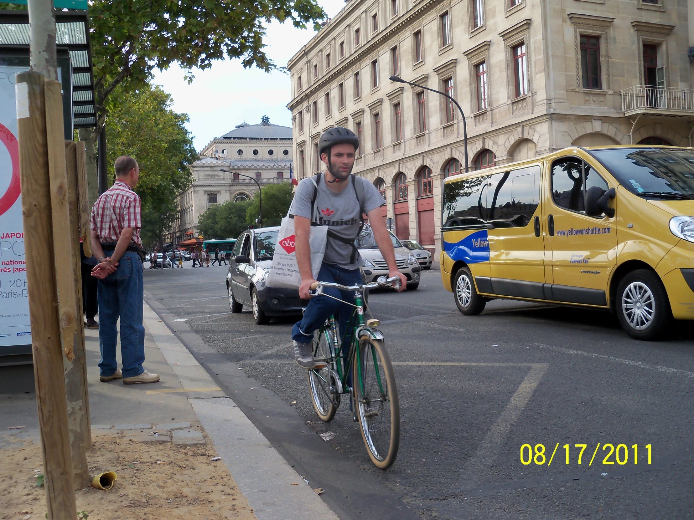 a man riding a bike down the street next to traffic