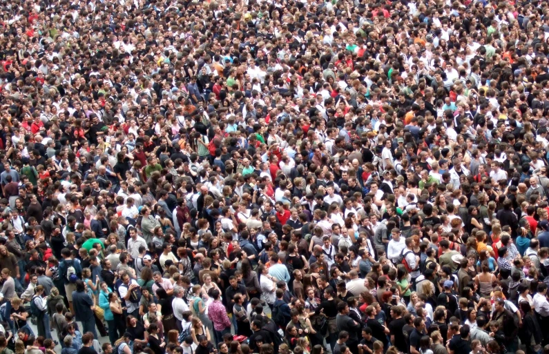 several large groups of people crowd together to greet and cheer at an outdoor event