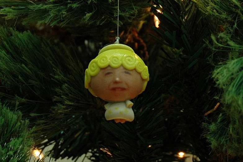 a green ornament with a girl face