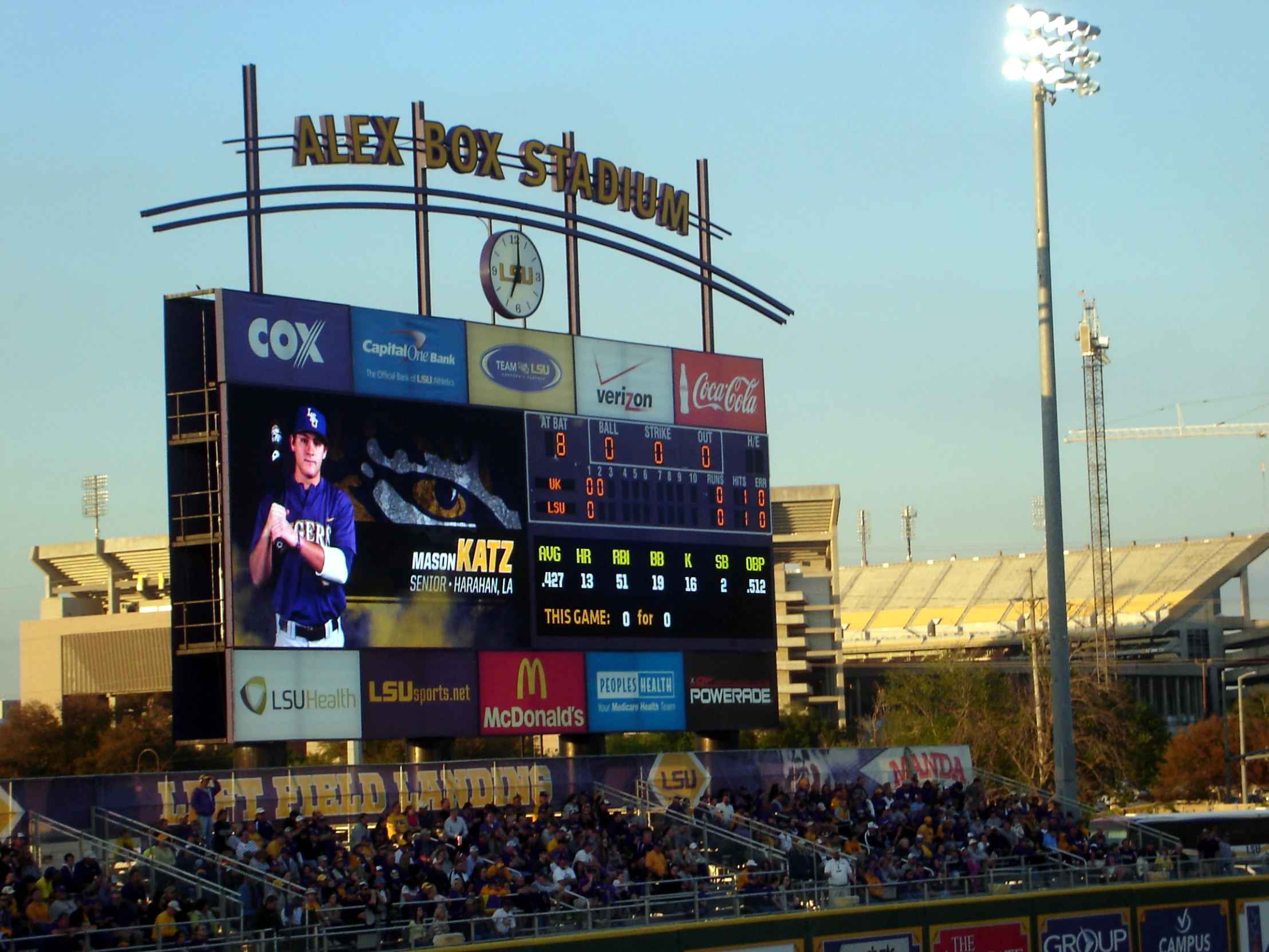 the score board on the baseball field is posted above the dugout