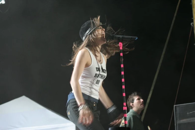 a woman standing in front of a microphone on a stage