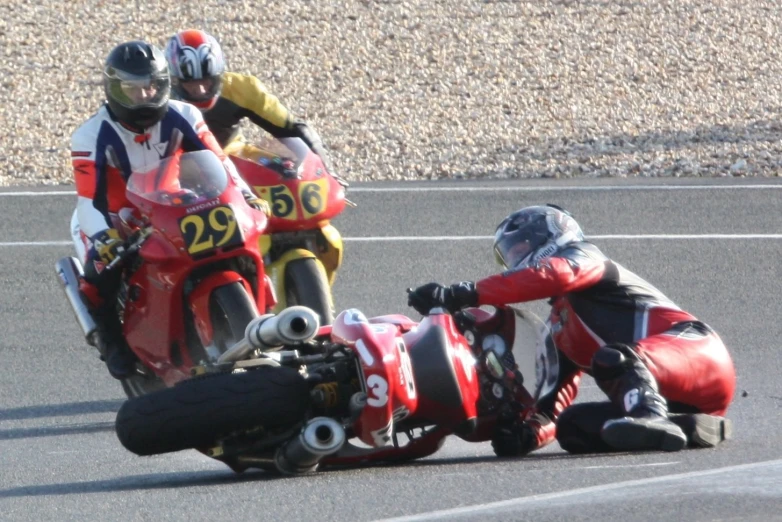 two people on the road riding motorcycles on the pavement