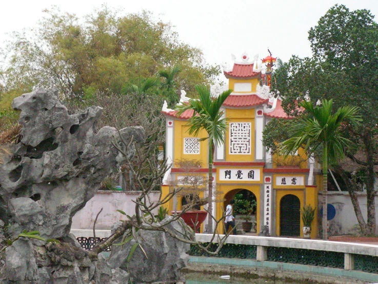 a yellow and red clock tower in an old town