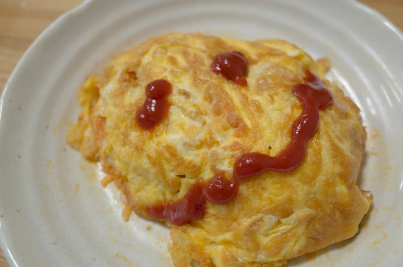 a puff pastry with ketchup on a plate