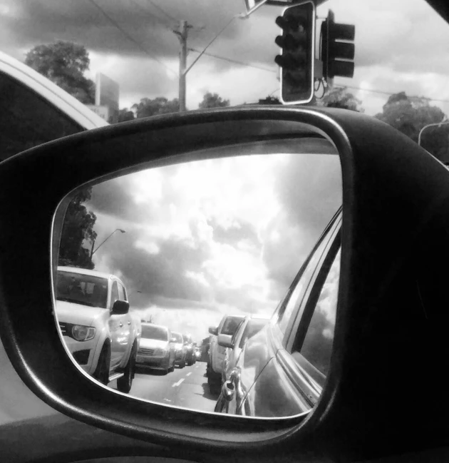 a rear view mirror reflecting traffic in it