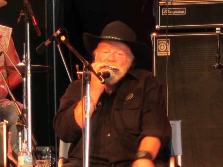 a man in a hat singing into a microphone