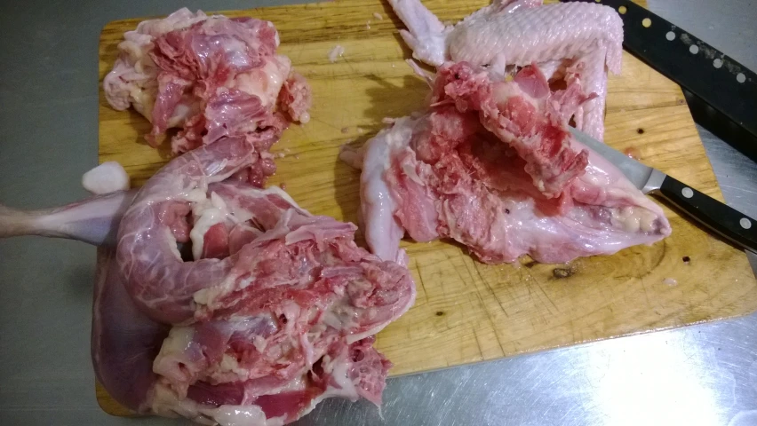raw pork chops laying next to a knife