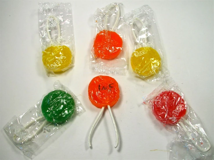 six lollipop lollipops wrapped in plastic cellophane