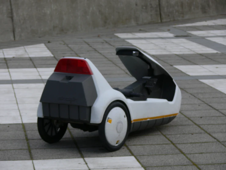 a car that is on the ground with white tiles