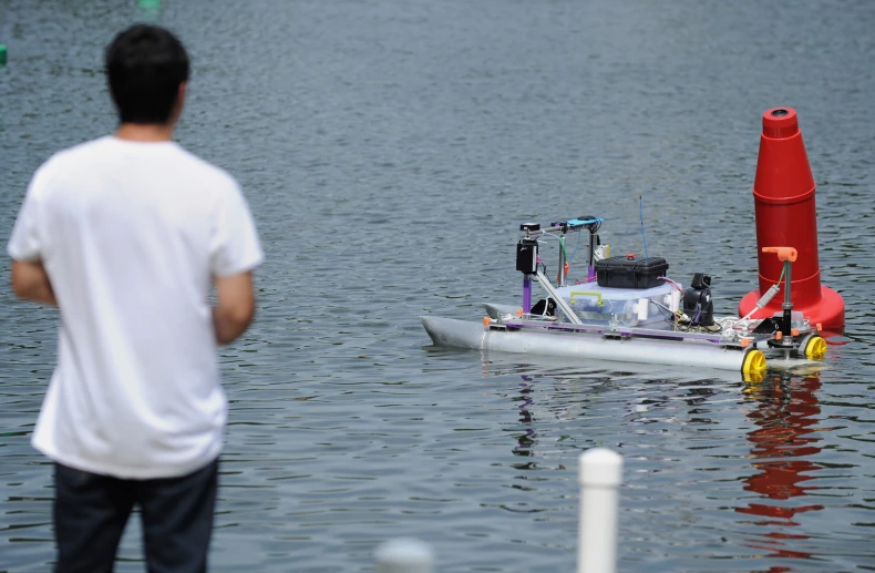 a man is standing near a small boat