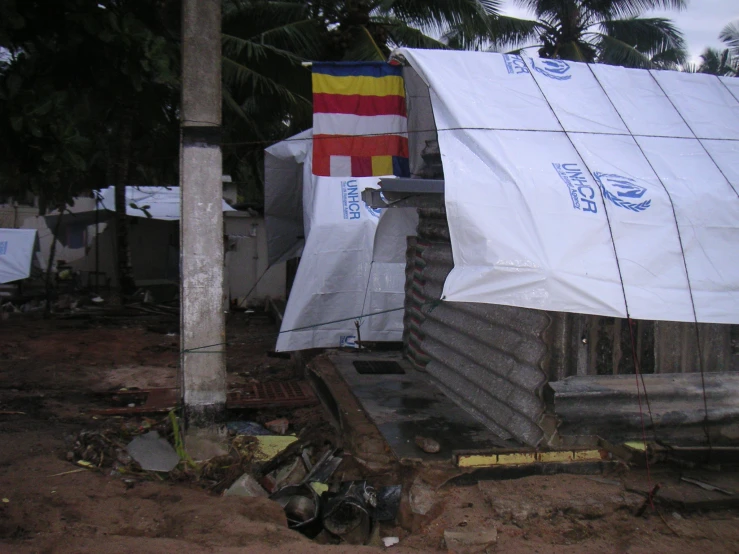 several cloth covered house appliances in front of trees