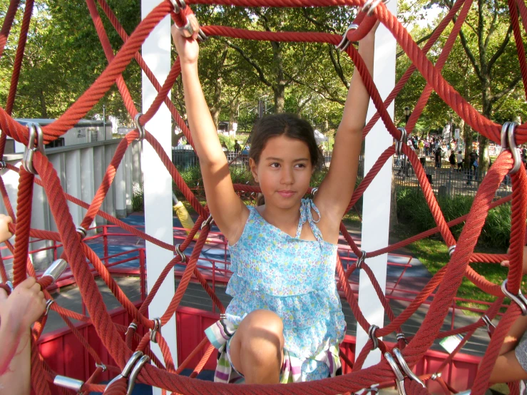 two s playing on a playground with ropes