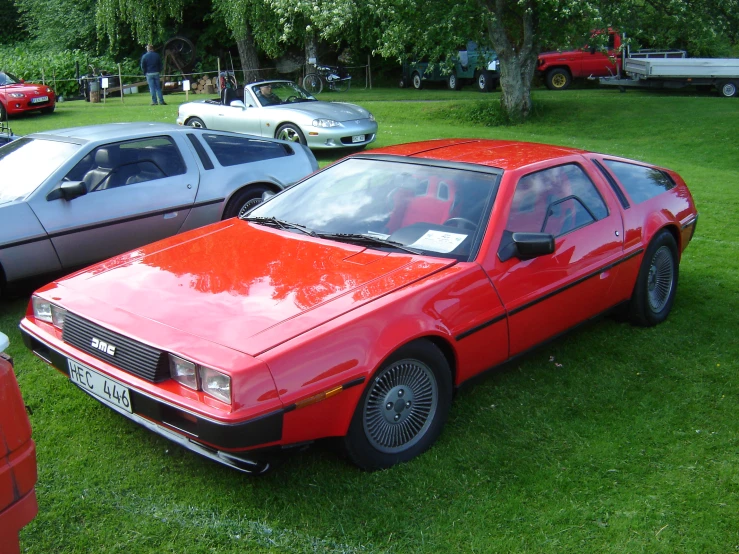 an old car parked next to a group of other cars