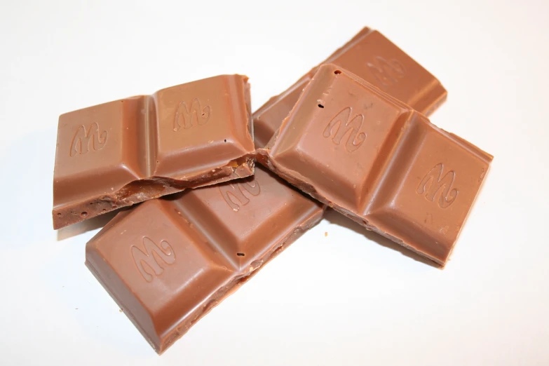 several pieces of chocolate on a white surface