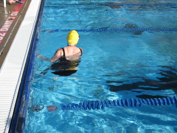 a swimming pool with a swimmer wearing a swimming hat