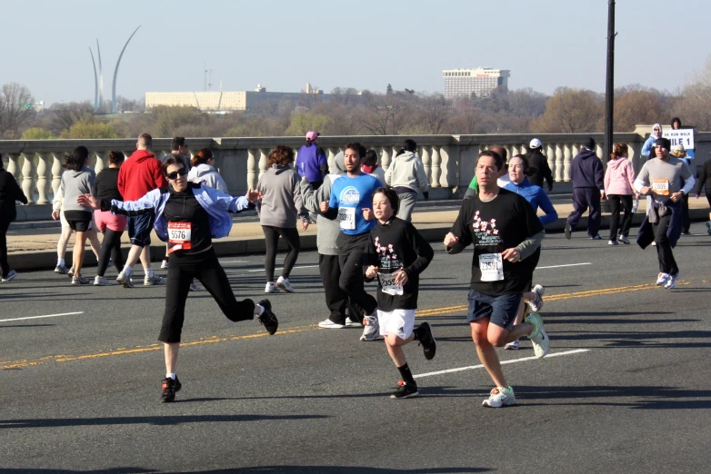 a group of people running on a bridge