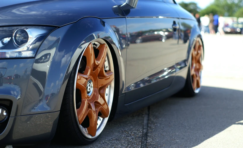 an image of a audi car with orange wheels