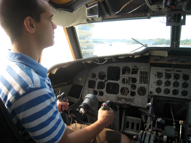 there is a man sitting in the cockpit of a plane