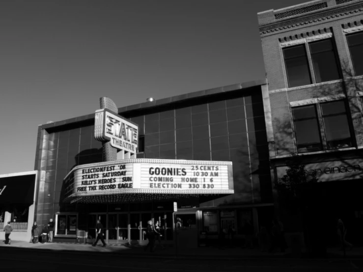 a large building with a marquee in front and a person walking near it