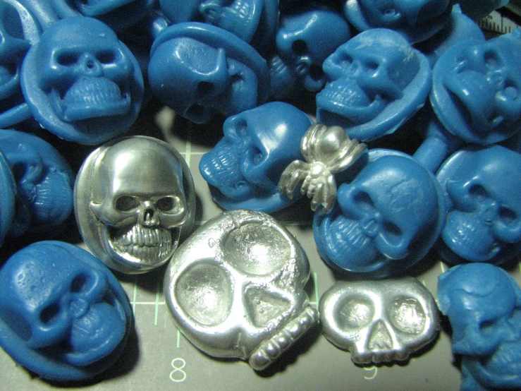a bunch of blue and silver on with skulls on them
